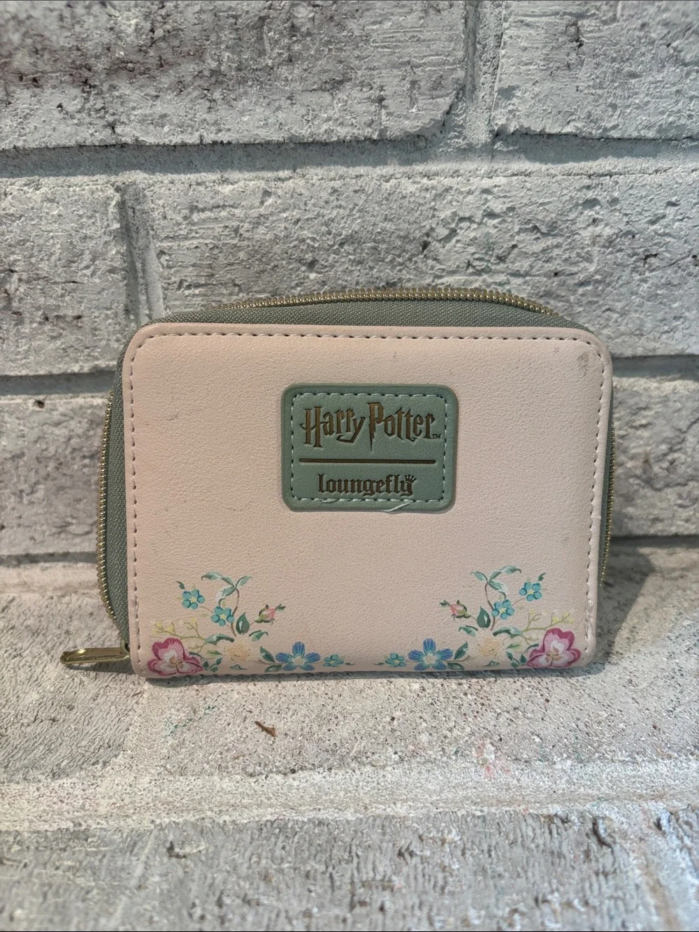 Loungefly Harry Potter Zip Card Holder with Deathly Hallows emblem.